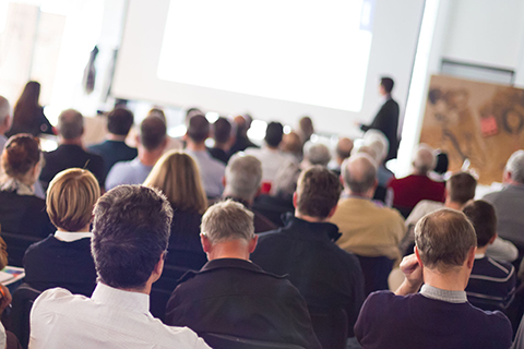 meeting with seated crowd